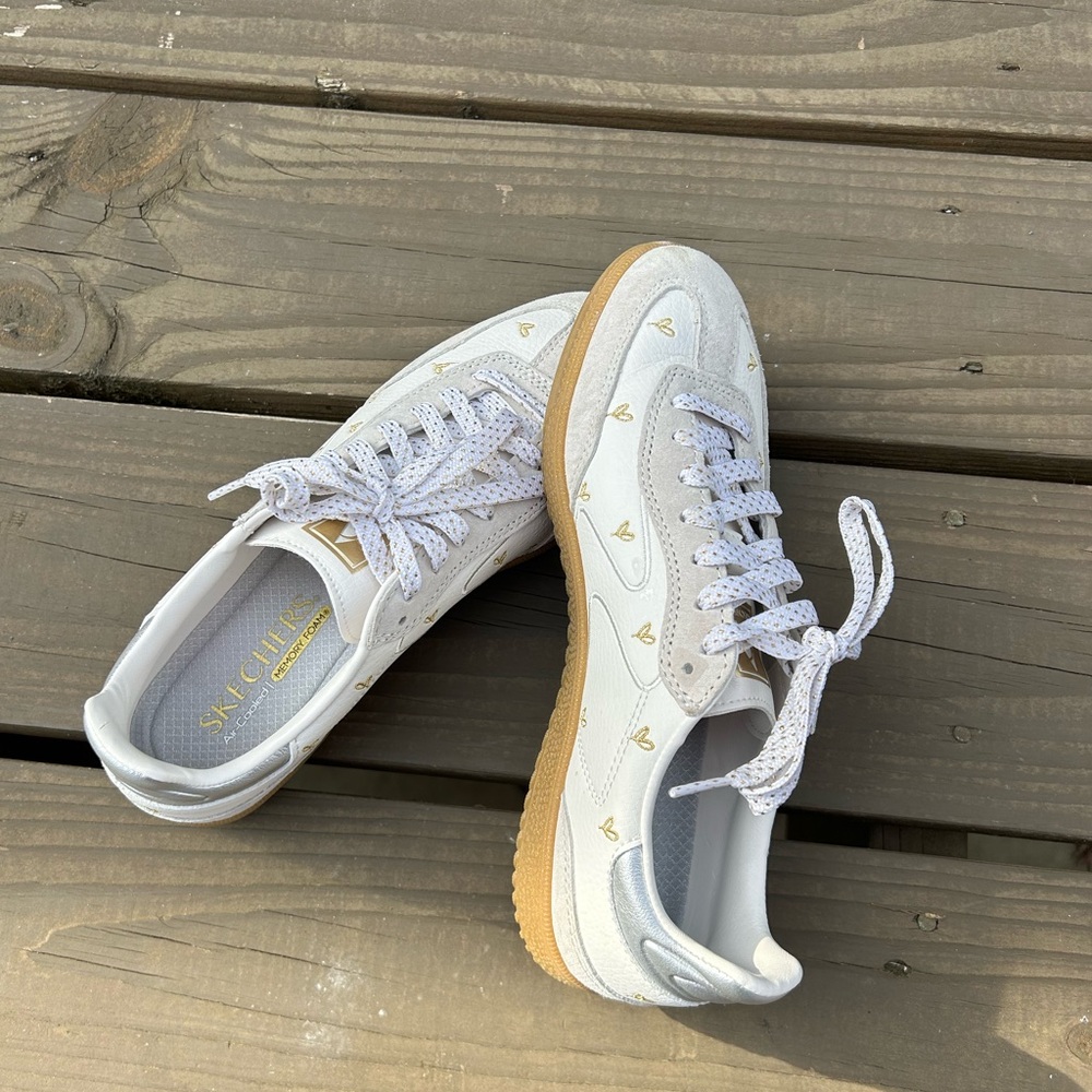 Skechers Women's White Sneakers with Gold Heart Details and silver on heel.